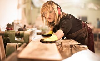 Blond woman working in carpentry workshop